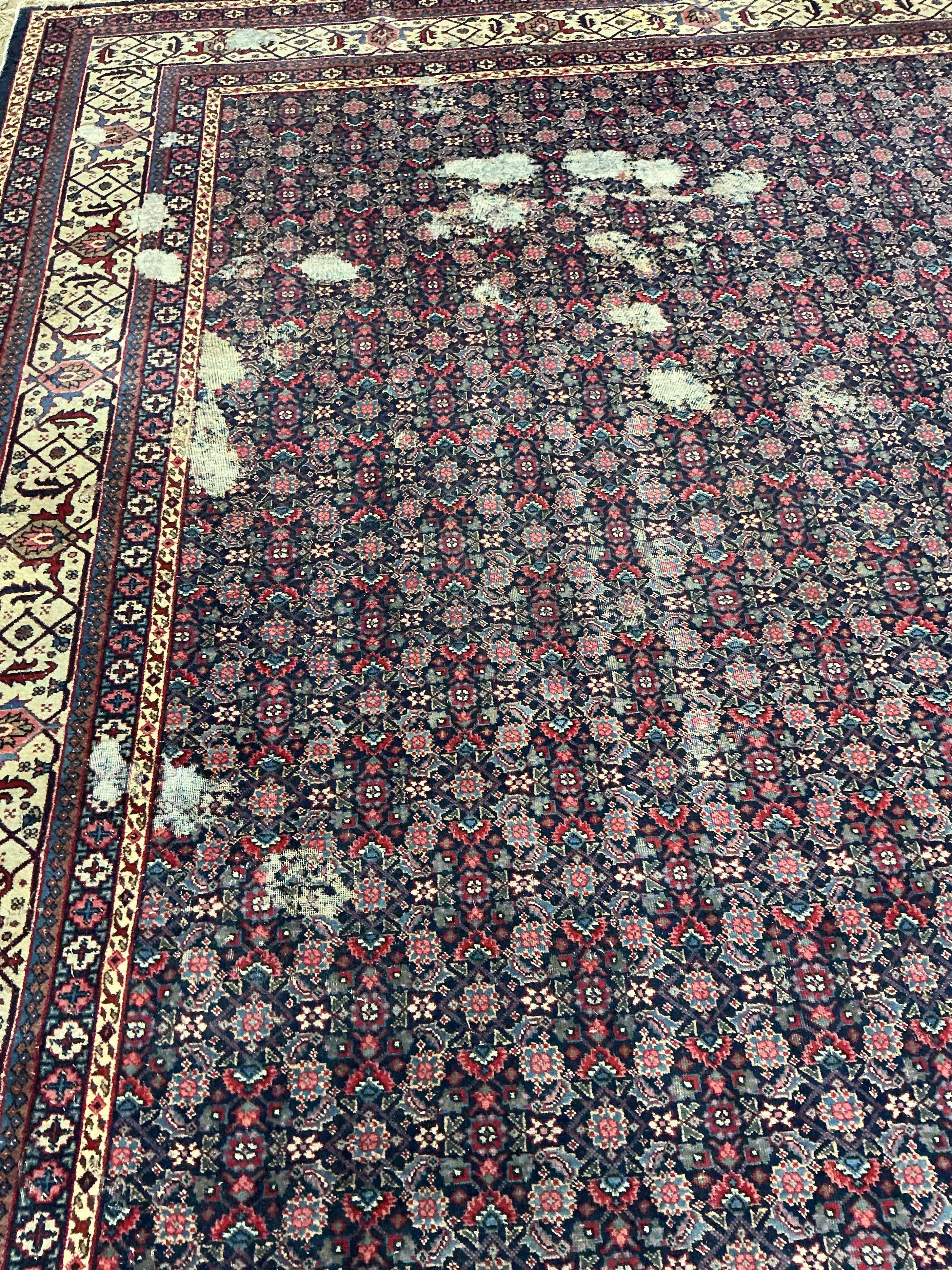 An early 20th century Tabriz blue ground floral carpet, moth damage, 440 x 340cm